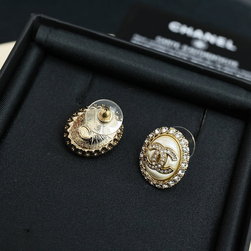 Round stud earrings with gold-toned CC logo and crystal halo, gold-tone post settings