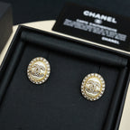 Round stud earrings with white enamel CC logo and crystal halo, gold-tone posts in box