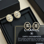 Round stud earring set with CC logos in crystal halos and black enamel, in gift box