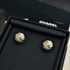 Chanel stud earrings, round gold-tone discs with embossed emblem and details