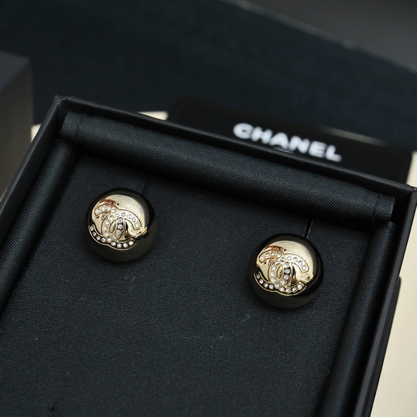 Chanel stud earrings, round gold-tone discs with embossed emblem and details