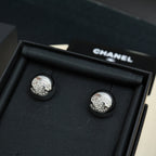 Chanel stud earrings, large round silver-tone discs with embossed emblem