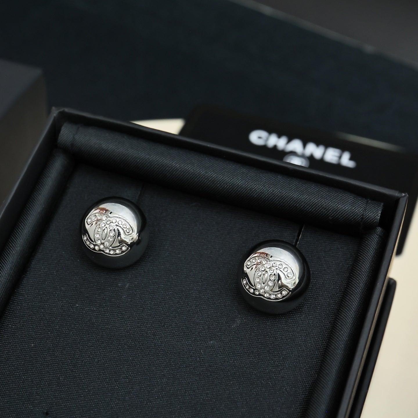 Chanel stud earrings, large round silver-tone discs with embossed emblem