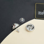 Chanel stud earrings close-up, round silver-tone fronts with post backs