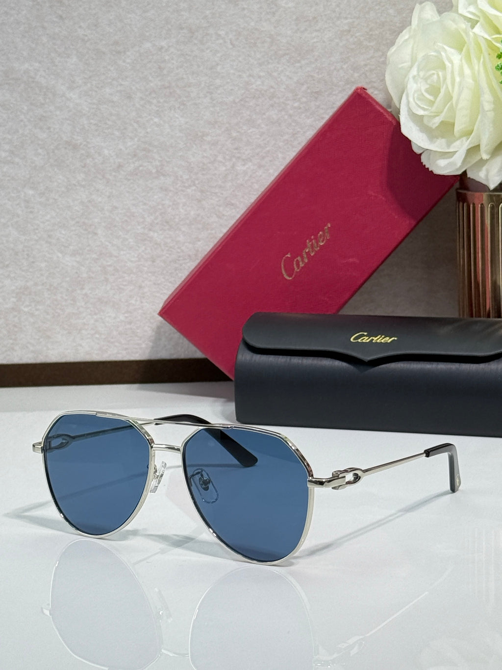 Cartier round-frame sunglasses with light gold frame and blue lenses
