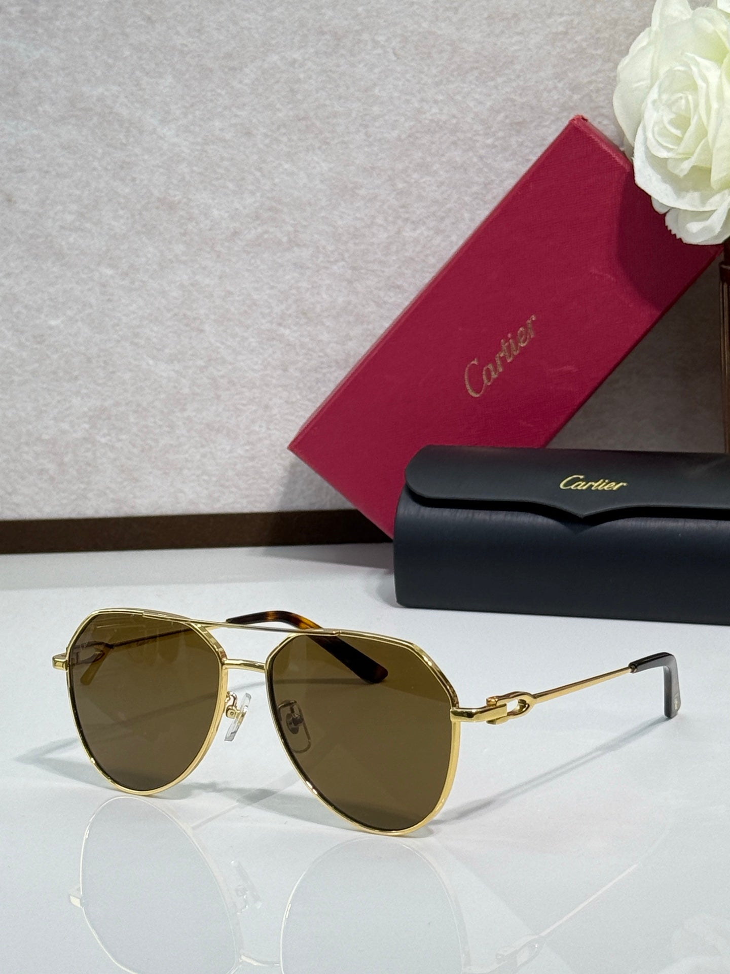 Cartier round-frame sunglasses with gold frame and olive-brown lenses