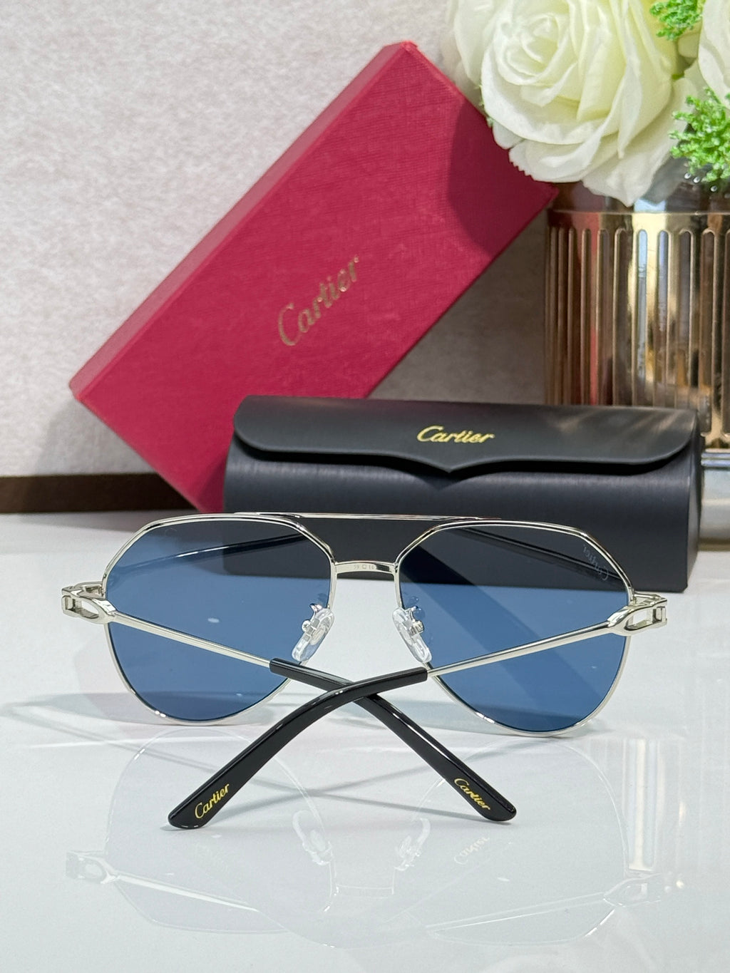 Cartier round-frame sunglasses with silver frame and blue lenses