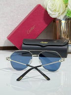 Cartier round-frame sunglasses with silver frame and blue lenses