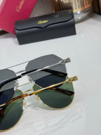 Cartier round-frame sunglasses showing mixed silver and gold hardware with dark lenses