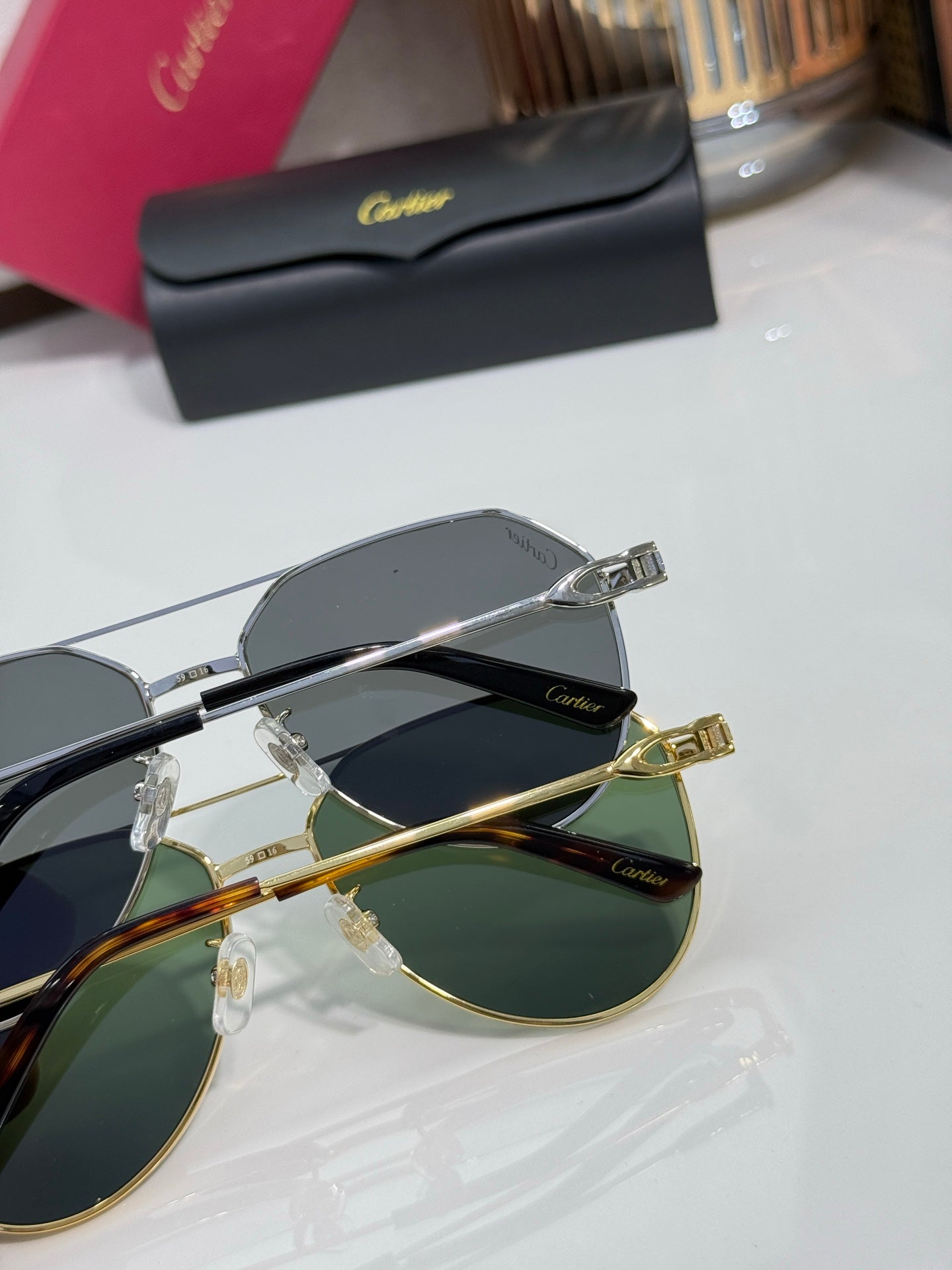 Cartier round-frame sunglasses showing mixed silver and gold hardware with dark lenses