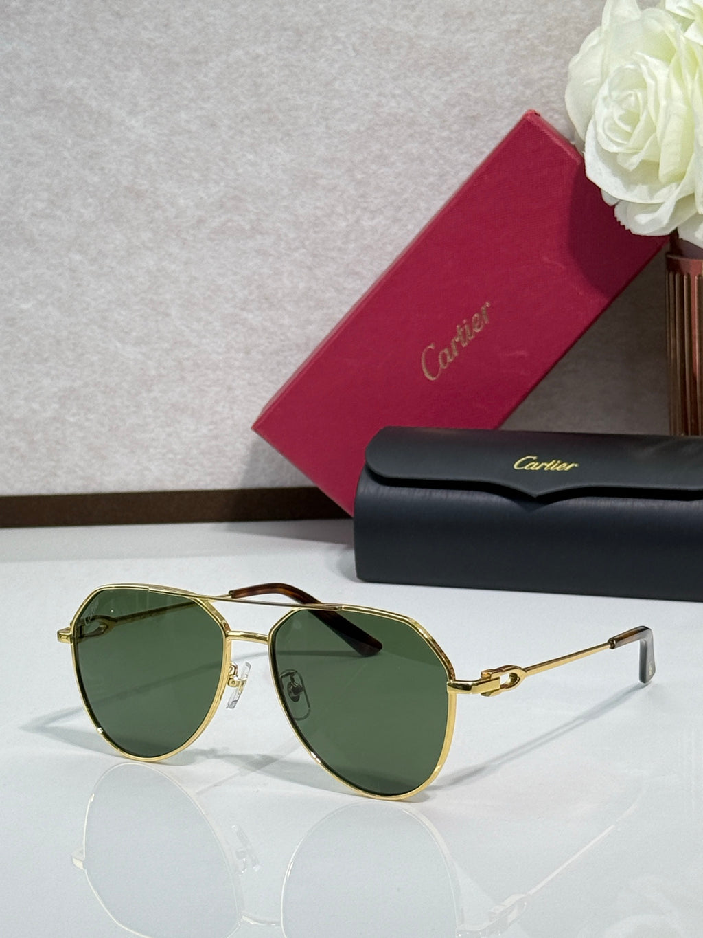 Cartier round-frame sunglasses with gold frame and dark green lenses
