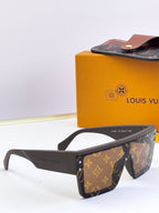 Louis Vuitton sunglasses with brown monogram pattern, angled view with clear white lenses