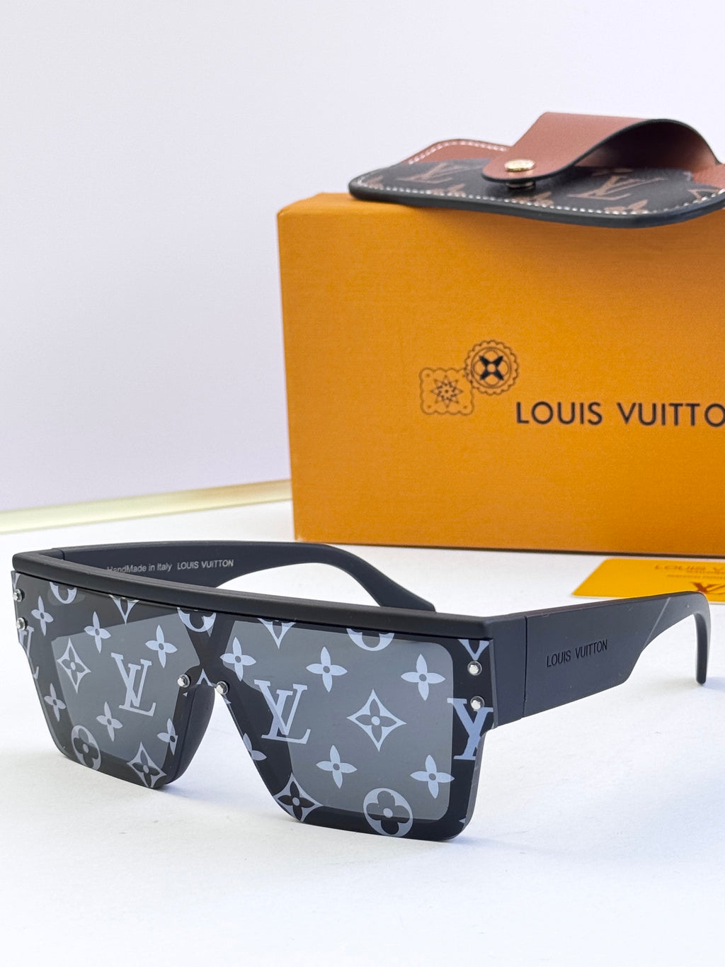 Louis Vuitton sunglasses with dark blue monogram patterned frames and clear lenses