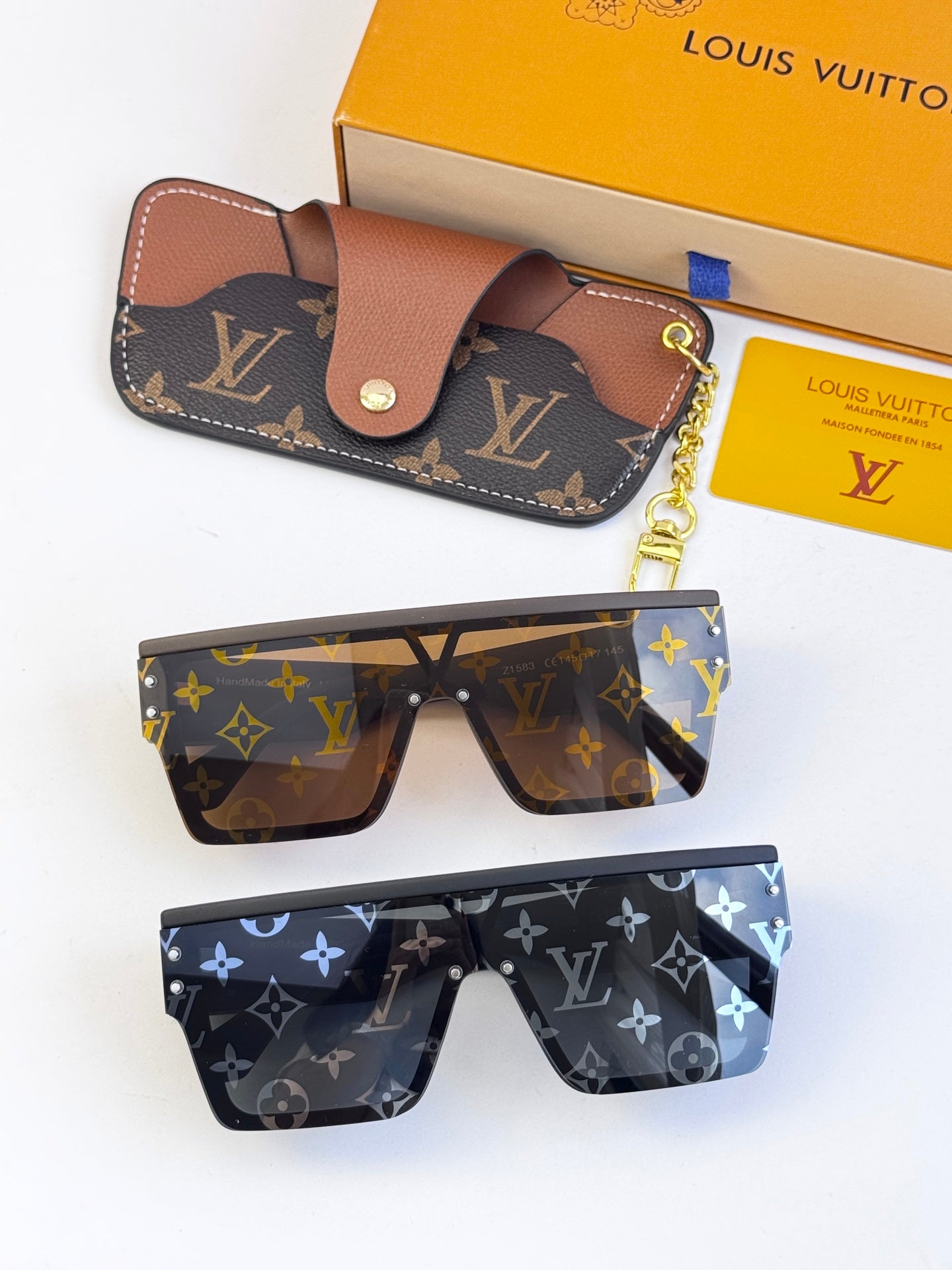 Louis Vuitton sunglasses set: dark blue and brown monogram frames plus small leather pouch