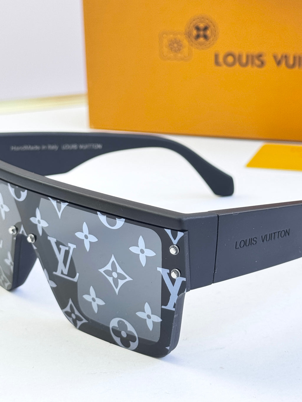 Louis Vuitton sunglasses top view with dark blue monogram pattern and black bridge