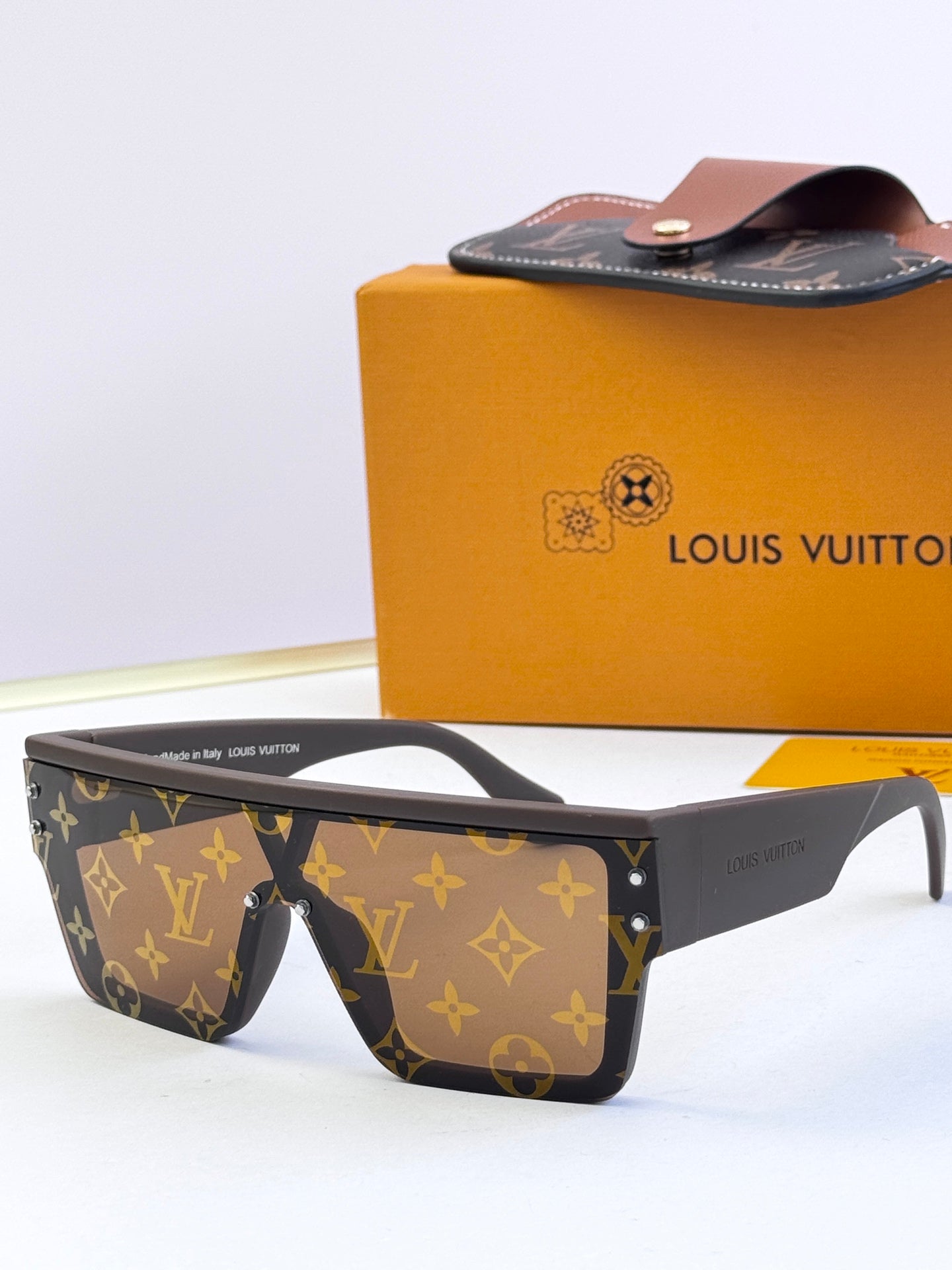 Louis Vuitton sunglasses with brown monogram pattern, rectangular frame and curved arms