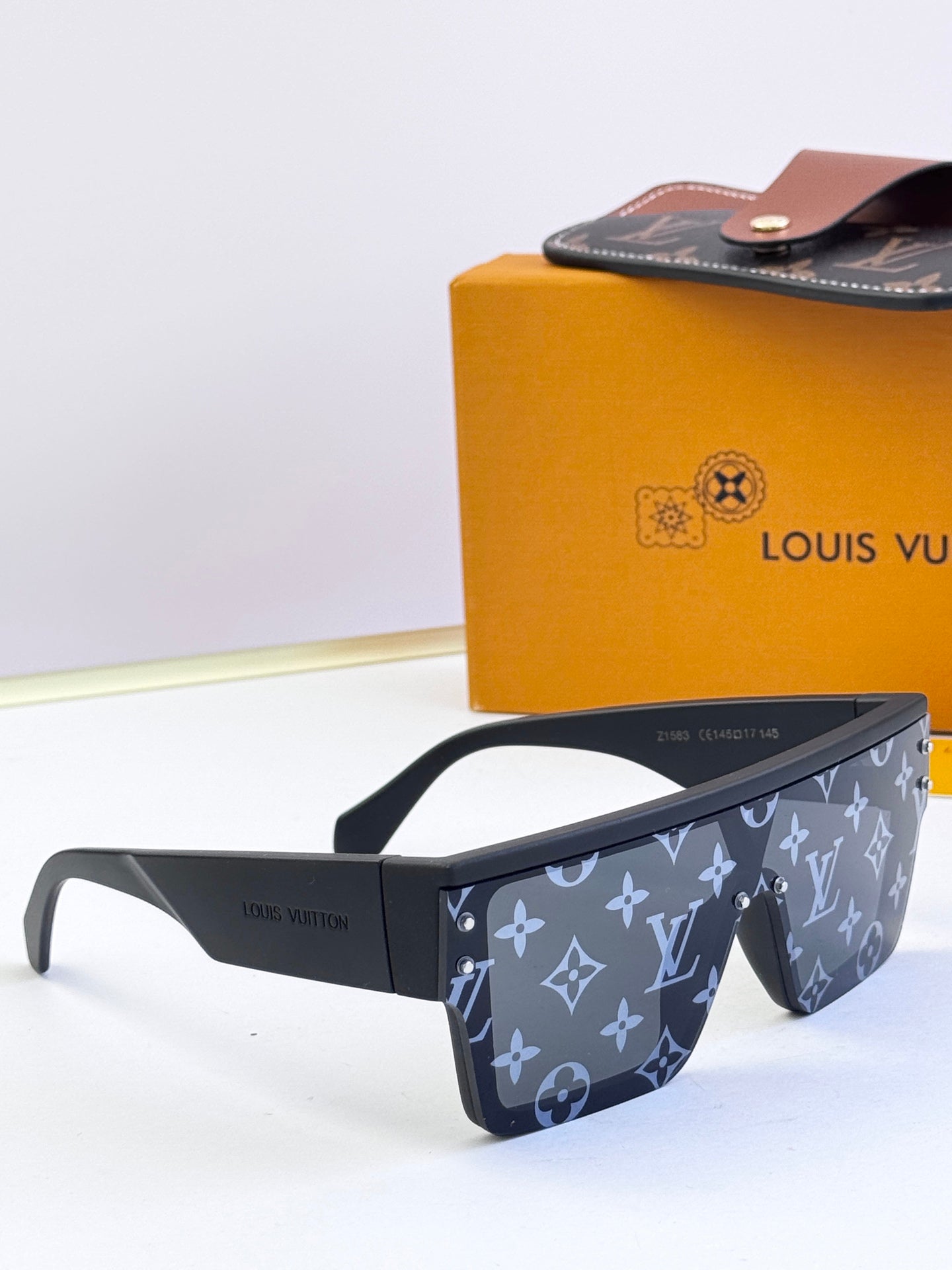 Louis Vuitton sunglasses, dark blue monogram pattern with straight temple arms and clear lenses