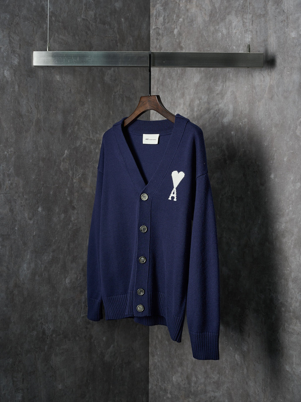 Navy knit cardigan with V-neck, button front, ribbed cuffs and white A heart emblem