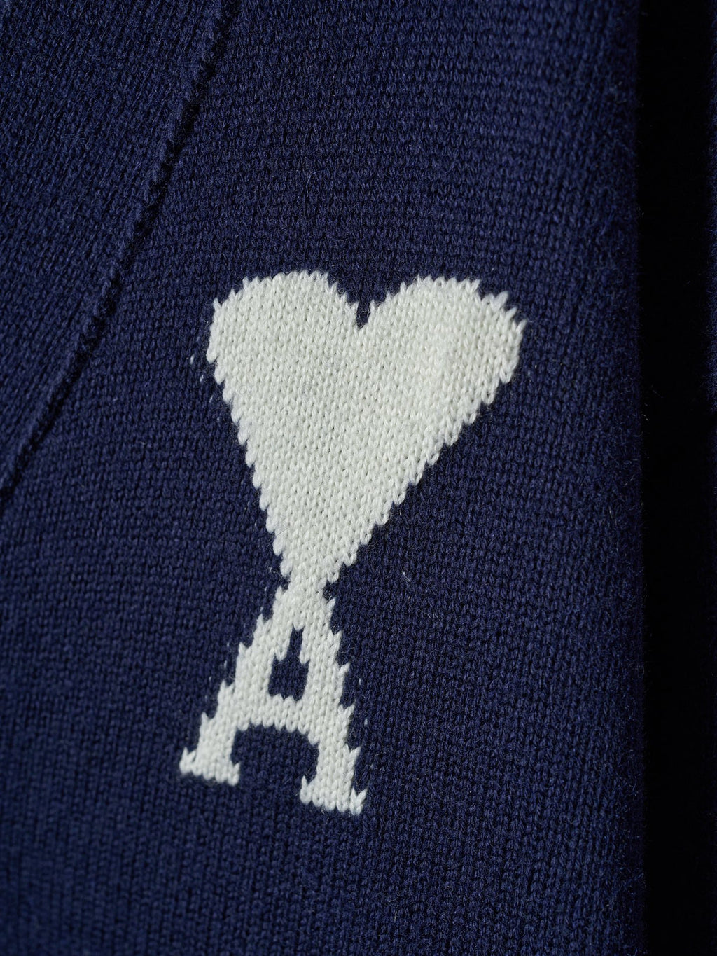 White heart and A emblem knit on navy cardigan fabric