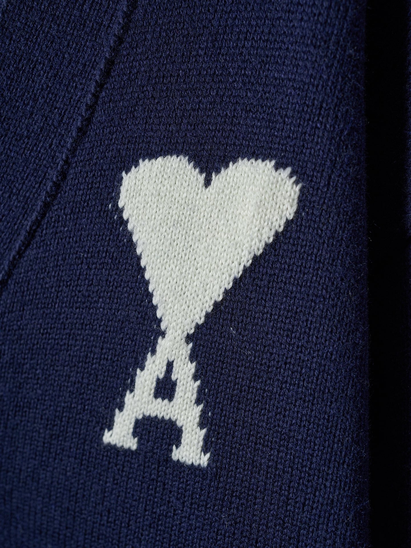 White heart and A emblem knit on navy cardigan fabric