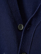 Navy knit cardigan close-up of button front with two dark olive-toned buttons