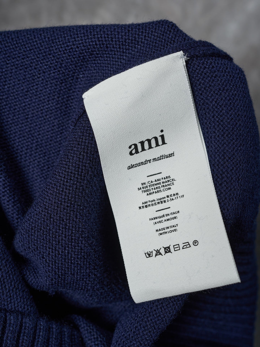 Navy knit cardigan care label tag on interior neck seam