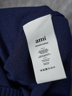 Navy knit cardigan care label tag on interior neck seam