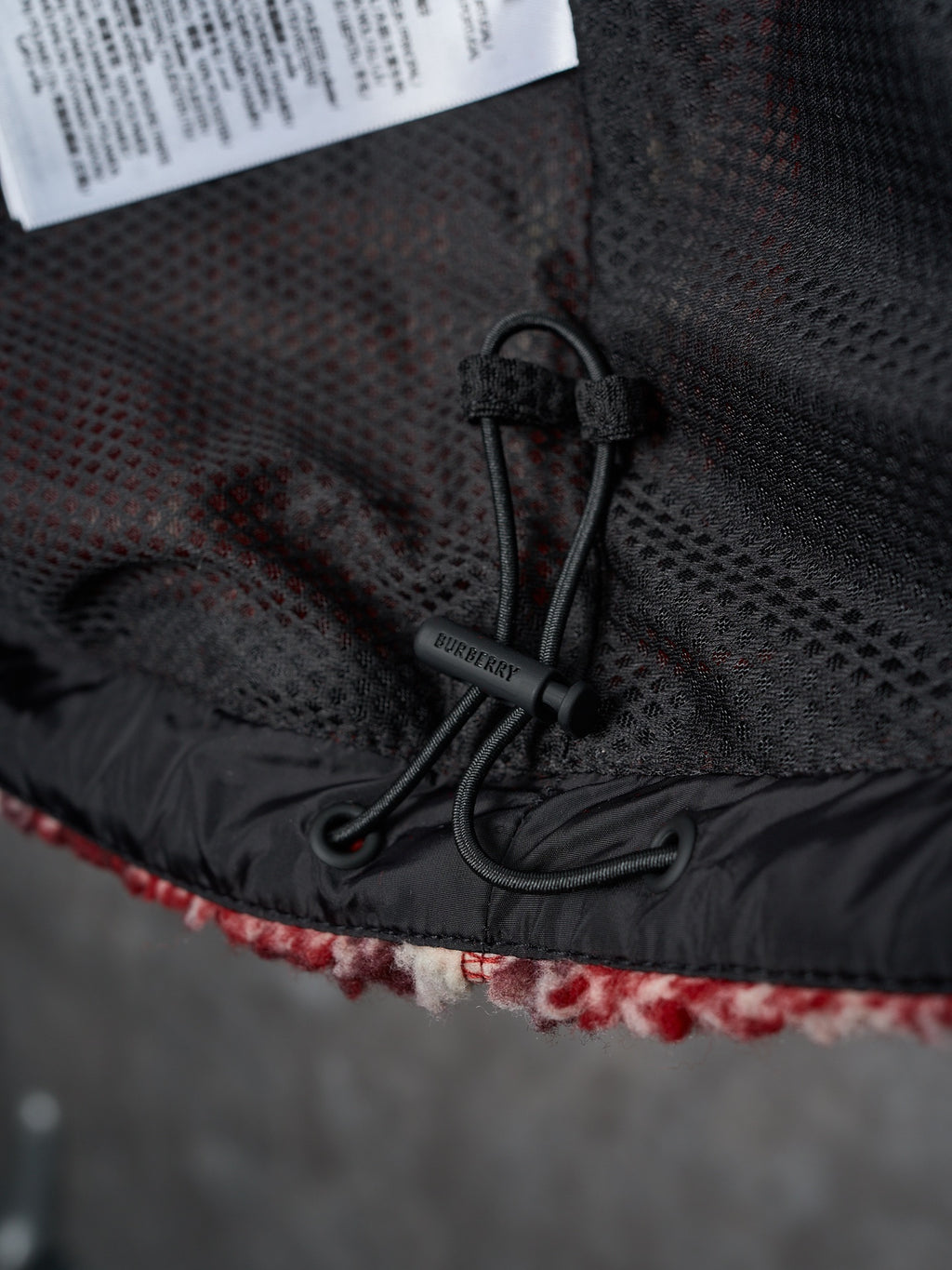 Black inner hood/lining with drawcord and Burberry brand tag