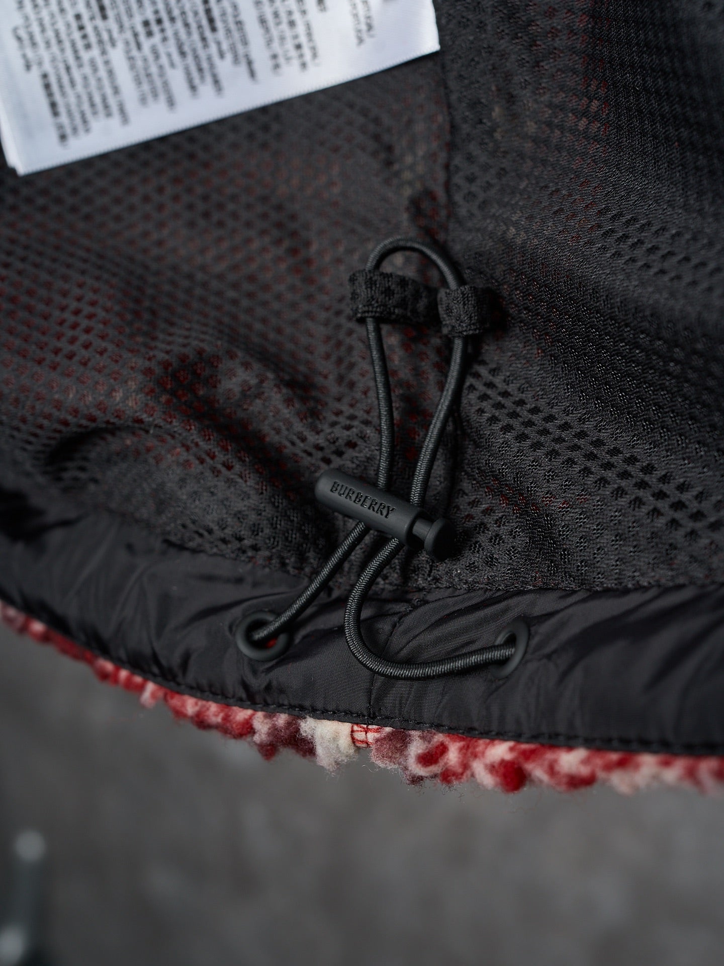 Black inner hood/lining with drawcord and Burberry brand tag