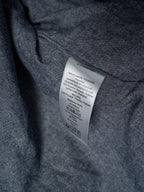 Long garment fabric with inner care label on dark gray textile