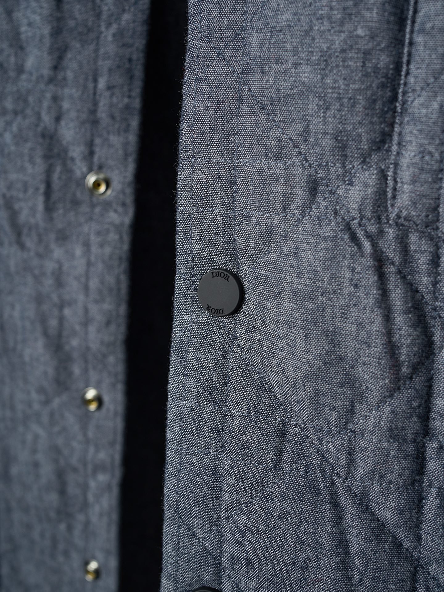 Dior jacket front detail with dark buttons and quilted fabric pattern