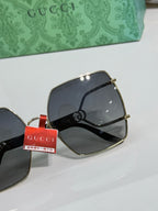 Gucci sunglasses side view with dark lenses, gold metal temples and hinge detail