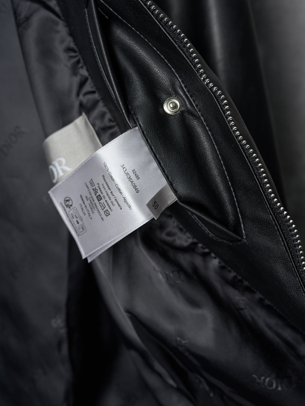 Dior black leather jacket front zipper and hangtags on inner placket