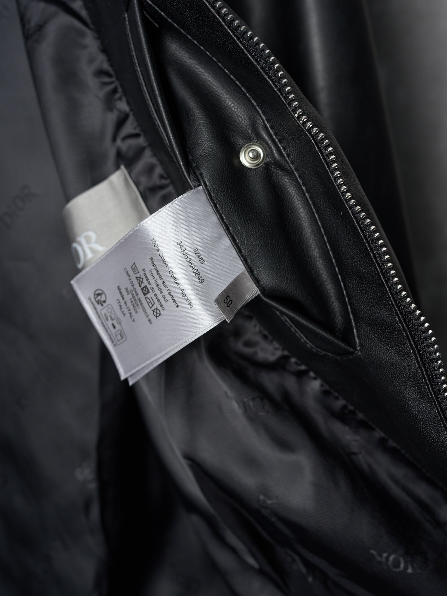 Dior black leather jacket front zipper and hangtags on inner placket