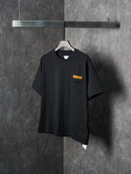 Black short-sleeve T-shirt with chest pocket and small yellow accent tab