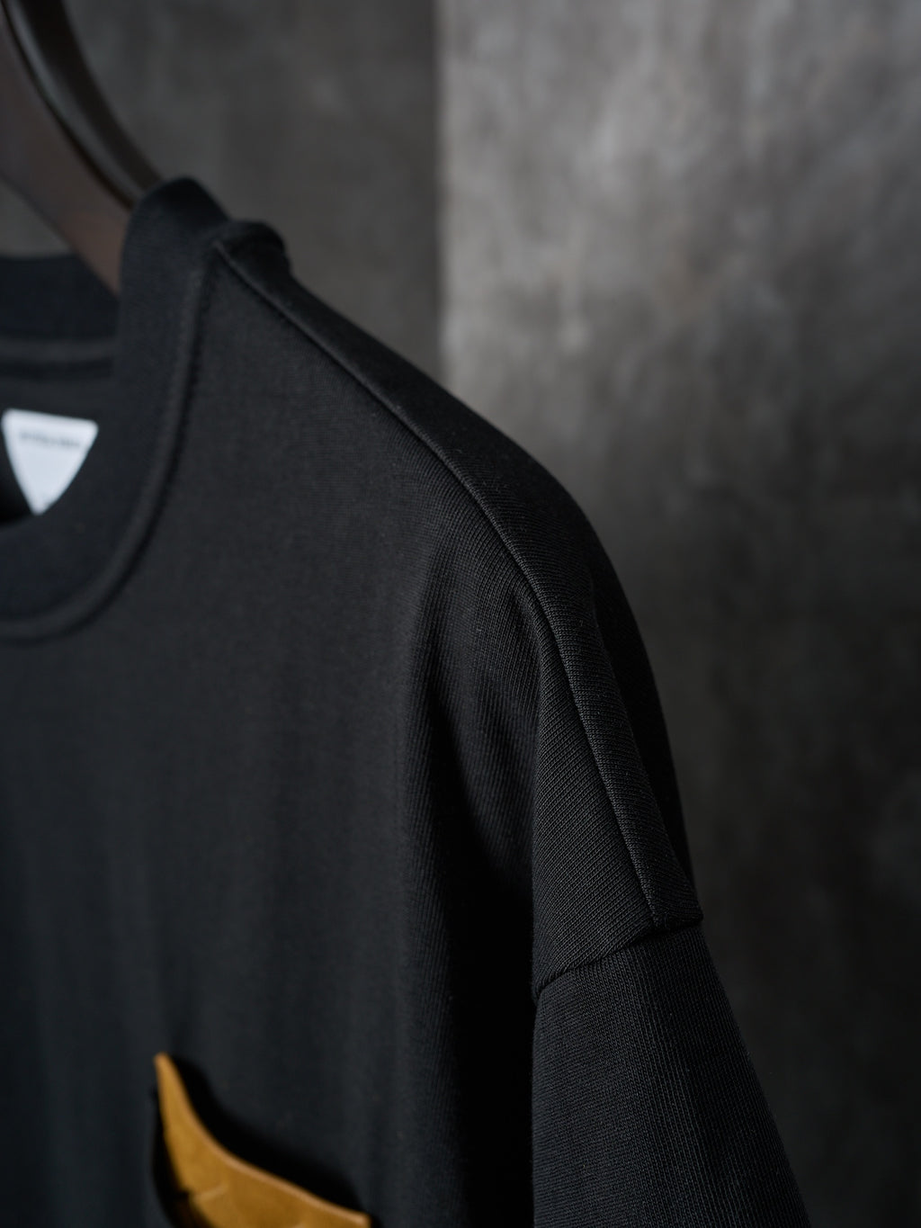Black T-shirt showing side seam and short sleeve detail