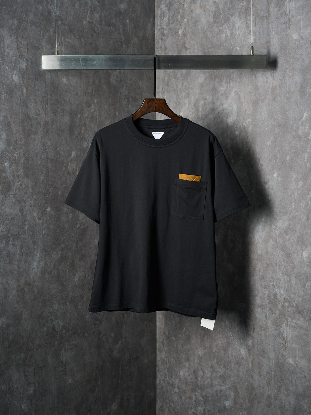Black short-sleeve T-shirt with chest pocket and small yellow accent