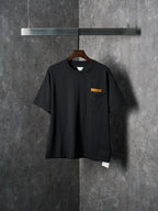 Black short-sleeve T-shirt with chest pocket and small yellow accent