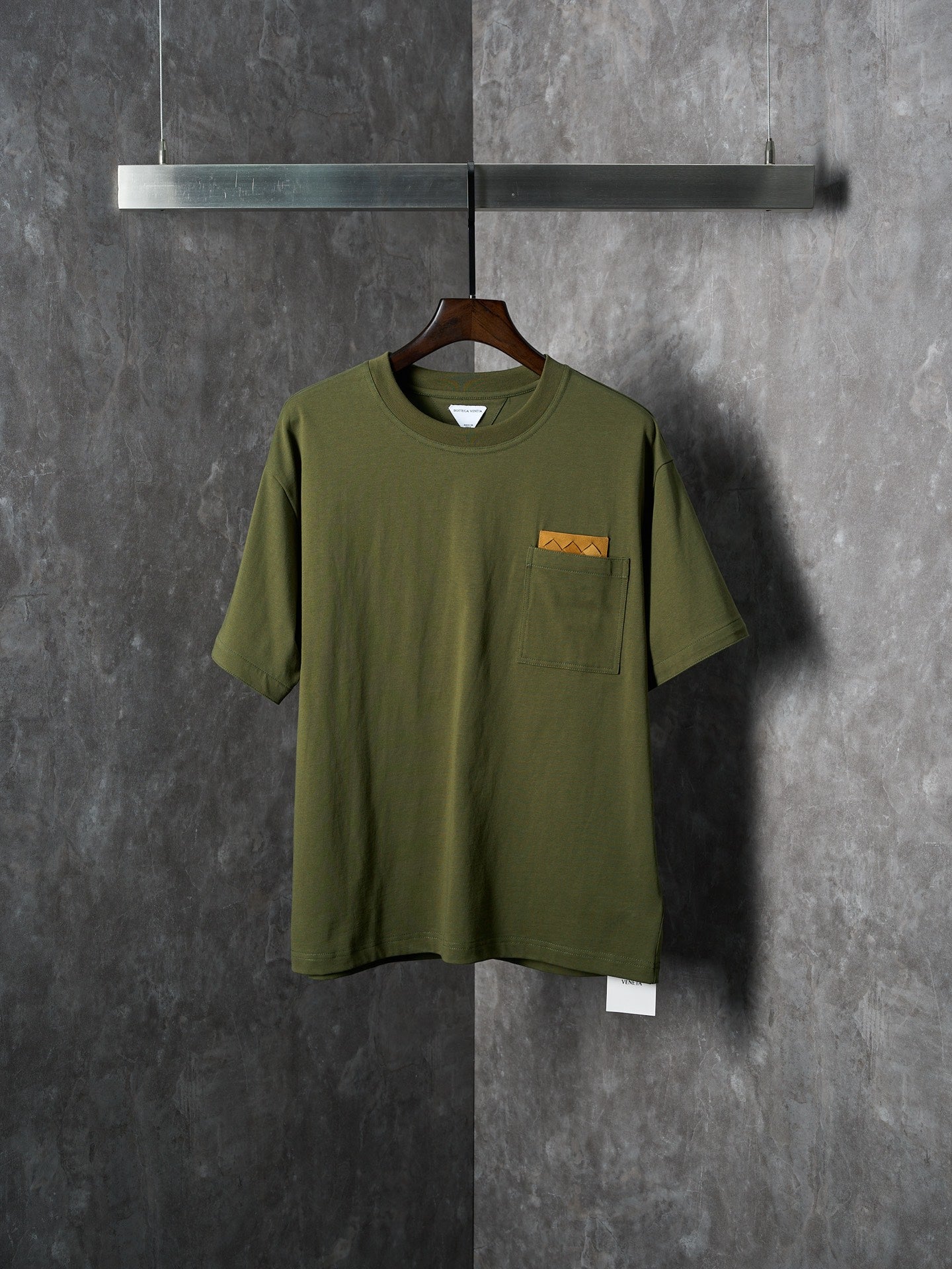 Olive green short-sleeve T-shirt with chest pocket and small logo label