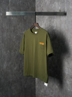 Olive green short-sleeve T-shirt with chest pocket and orange logo patch