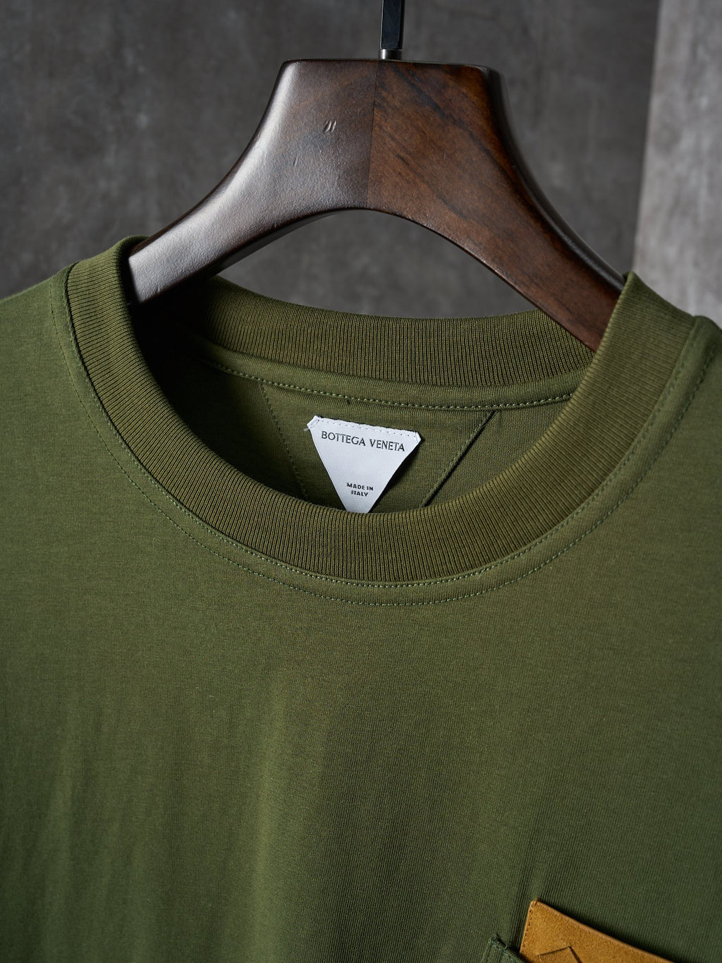 Olive green crew-neck T-shirt with inner neck brand label