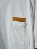 Off-white T-shirt chest pocket with brown braided patch and stitched pocket edges