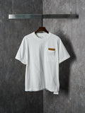 Off-white T-shirt with crew neck and chest pocket featuring a brown embroidered patch