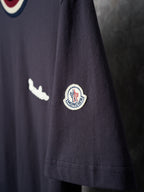 Navy T-shirt sleeve with circular logo patch