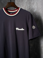 Navy short-sleeve T-shirt with Moncler script logo and circular sleeve patch