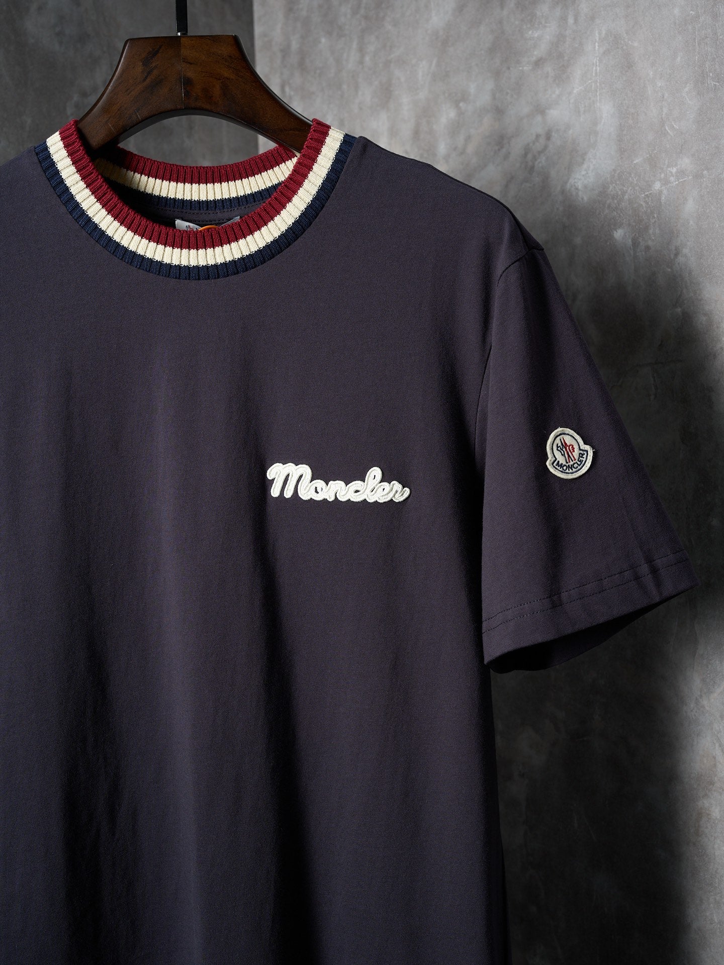 Navy short-sleeve T-shirt with Moncler script logo and circular sleeve patch