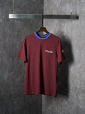 Burgundy short-sleeve T-shirt with ribbed striped crew neck and small chest logo