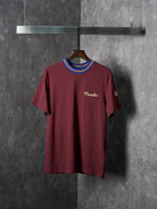 Burgundy short-sleeve T-shirt with ribbed striped crew neck and small chest logo
