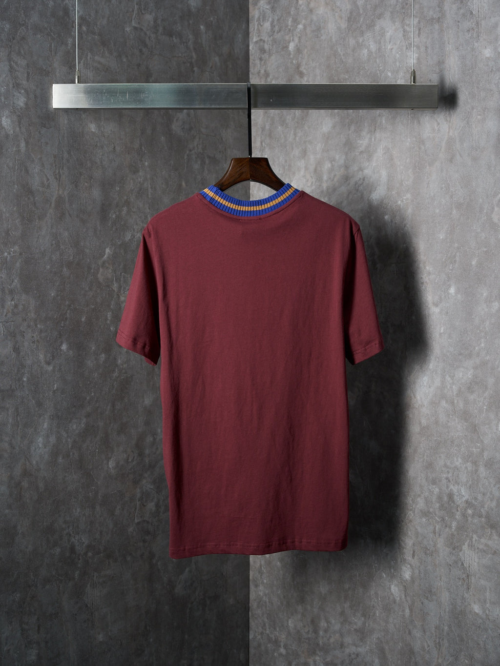 Burgundy short-sleeve T-shirt on hanger, crew neck with blue yellow striped rib
