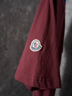 Burgundy T-shirt sleeve with round Moncler patch logo